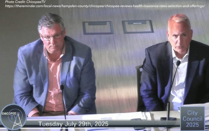 Mayor John Vieau (left) and Marc Criscitelli (right) from HUB International discuss and present health insurance rates in Chicopee.